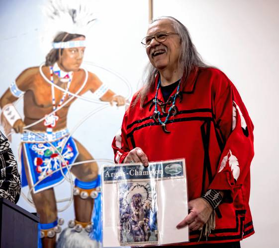 Don Standing Bear Forest holds up a copy of the Argus-Champion newspaper at the Mt. Kearsarge Indian Museum before his opening remarks discussing his book, 
