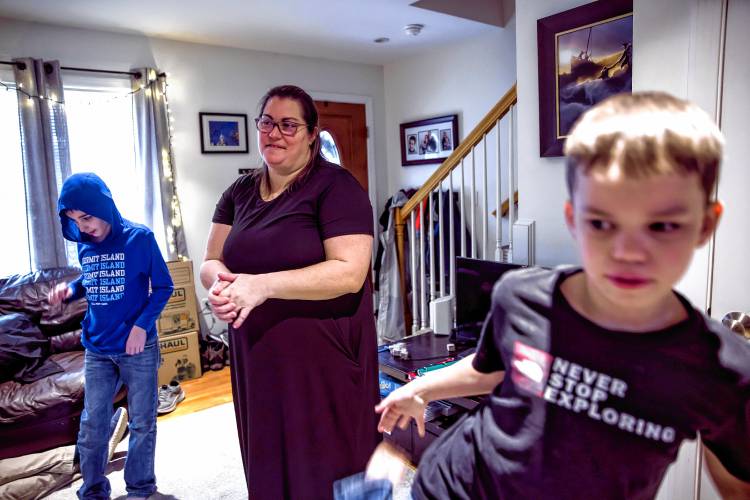 Kristen LeGeyt’s living room is a busy place with sons Bryce, left, and Ryan being boys and doing their school work.