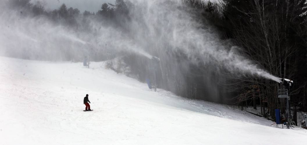 A snowboarder makes his way down the mountain at Attitash ski area in Bartlett, N.H. A snowboarder makes his way down the mountain at Attitash ski area in Bartlett, N.H.