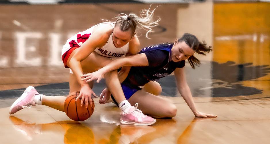 Concord Christian guard Lilli Carlile (right) battles for the ball with Bedford guard Sarah Muir at midcourt during the first half of the Division I girls’ basketball semifinals at Exeter High School on Monday. Concord Christian lost to undefeated Bedford, 58-34.