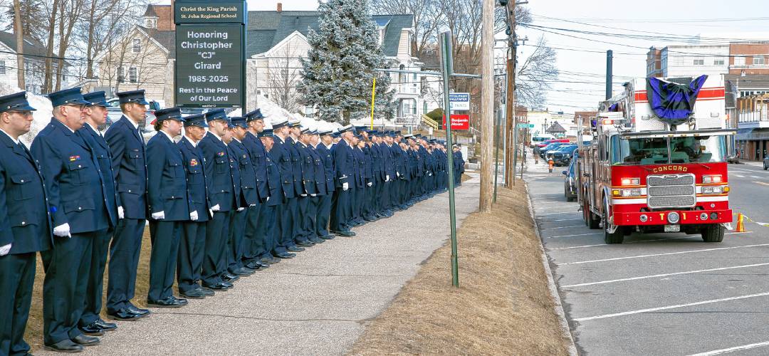 Firefighters from around the state line up outside Christ the King Parish in Concord as Tower One leads the hearse carrying Concord firefighter Christopher ‘CJ’ Girard on March 13.