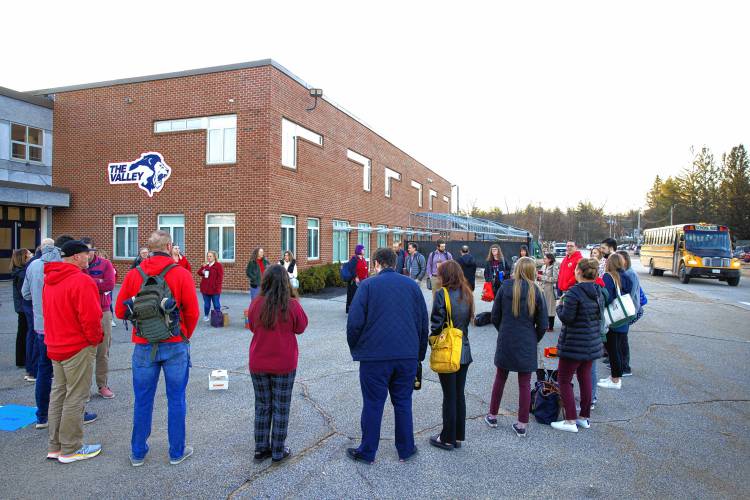 Merrimack Valley High School teachers stand outside the school on Wednesday morning as the school buses arrived and school was about to begin.