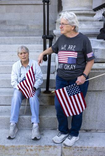 Kit Hansen (left) and Kathy Ireland, from Goffstown, came to the Hands Off Medicaid rally  on Thursday.