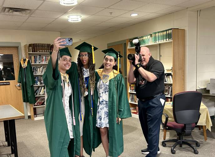 Kailyn Medina (left) takes a selfie with Aleah Ryan (center) and Briana Medina as longtime graduation photographer Greg Fortier captures the moment prior to Bishop Brady High School graduation on Friday, June 6, 2025.
