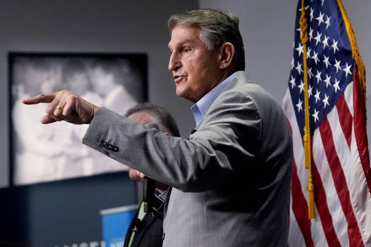 Sen. Joe Manchin, D-W.Va., gestures while addressing guests during the Politics and Eggs event, as part of his national listening tour, Friday, Jan. 12, 2024, in Manchester, N.H. Manchin announced last November that he would not seek reelection in 2024 and has teased a potential third-party run for the presidency. (AP Photo/Charles Krupa)
