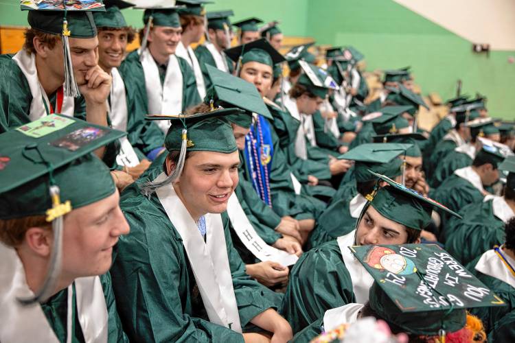 Hopkinton graduate Avery Condon sits with his classmates as they await the class photo in the gymnasium before the graduation ceremony on Friday.