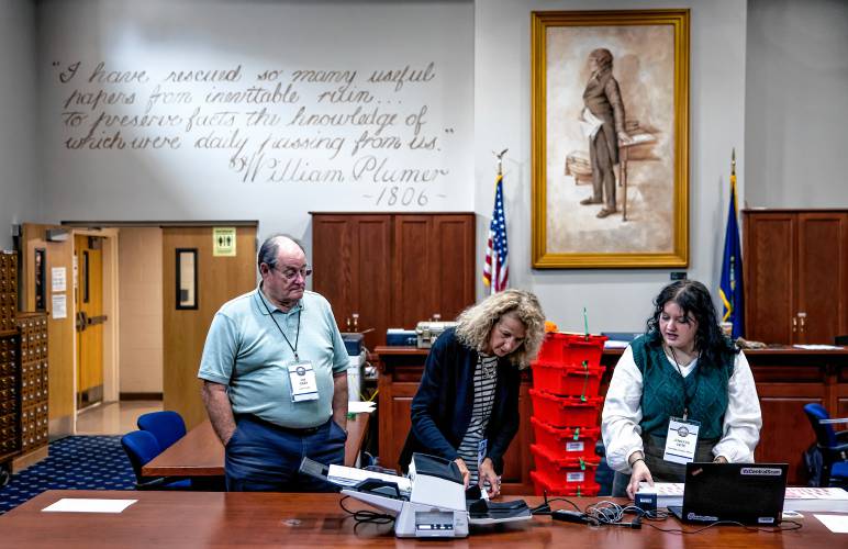 Senior Deputy Secretary of State Patricia Lovejoy (center), along with audit team member Jim Gray (left) and Assistant Secretary of State Jennifer Cote prepare the ballots from Winchester to be fed into the high speed scanner at the State Archives in Concord on Wednesday, September 11, 2024.
