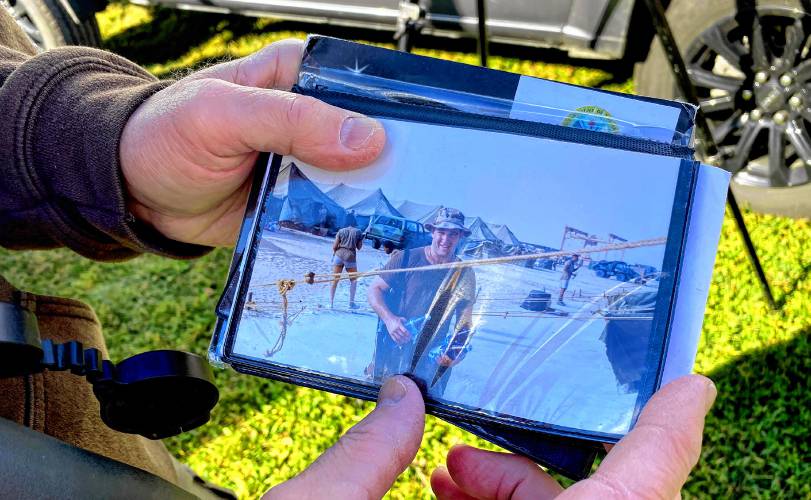 Gulf War veteran Robert Vallieres shows a photo of himself during the conflict. Vallieres helps other veterans discover the joy of bird watching.