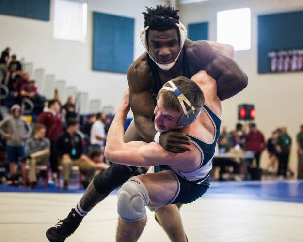 Concord’s George Tarwo, left, during the 182-pound Division I semifinal championship match at Londonderry High School in 2017. Tarwo went on to win the championship.