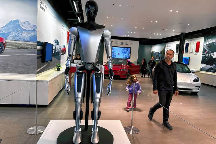 A non-working marketing model of Tesla Inc.’s proposed Optimus humanoid robot, aka Tesla Bot, is on display at the Westfield Garden State Plaza in Paramus, New Jersey, on Thursday, Nov. 2, 2023. A non-working marketing model of Tesla Inc.’s proposed Optimus humanoid robot, aka Tesla Bot, is on display at the Westfield Garden State Plaza in Paramus, New Jersey, on Thursday, Nov. 2, 2023.