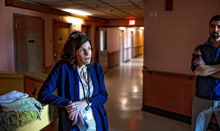 Merrimack County Nursing Home administrator Heather Moquin stands at the nursing station of unrenovated portion of the McLeod Building at the Merrimack County Nursing Home on Monday, March 3, 2025. Moquin started as an LNA at that unit.