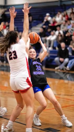 Concord Christian guard Lilli Carlile (right) finds her route to the hoop obstructed by Bedford’s Melody McCarthy.