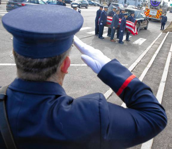 Firefighters salute as the casket of Concord firefighter Christopher âCJâ is carried into Christ the King Parish in Concord on Thursday, March 13, 2025.