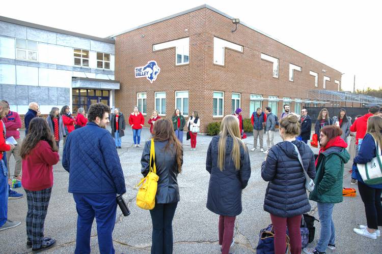 Merrimack Valley High School teachers stand outside the school on Wednesday morning as the school buses arrived and school was about to begin.