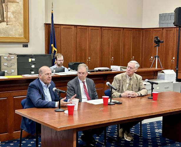 Former U.S. Sen. John E. Sununu (left) addresses a crowd of local moderators at a panel at the State Archives on Monday, June 2, 2025. Secretary of State David Scanlan (center) and former U.S. Rep. Richard Swett (right) also spoke.