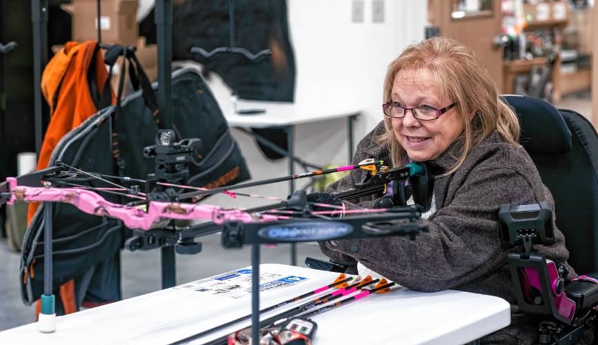 Melinda Simms gets ready to shoot with her custom bow at Coyote Creek Archery in Rochester on Thursday.