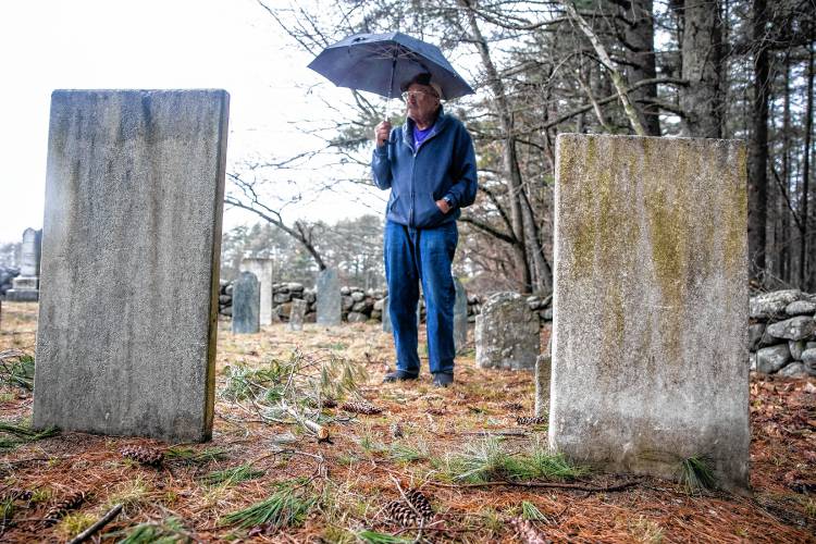 Norm Yeaton looks over the grave markers in the private Yeaton cemetery off of Black Hill Road in Dpsom on Thursday, April 11, 2024. Yeaton has taken on the arduous research project by Yeaton to understand the sheer volume of people in Epsom whose last name was the same as his--even when the name was Yeton before they added the ‘a’ sometime in the 19th century.