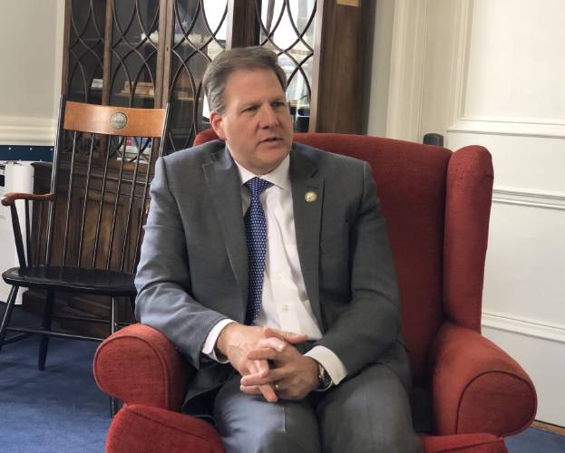 Gov. Chris Sununu talks with reporters in April 2023.