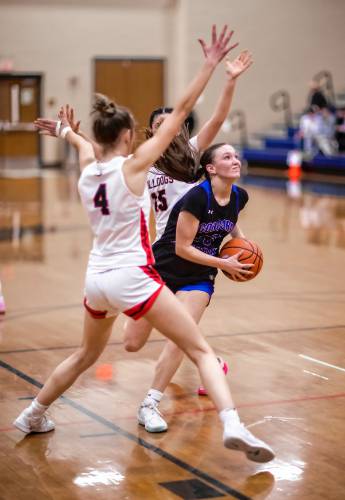 Concord Christian guard Lilli Carlile (right) splits two Bedford defenders during the second half at Exeter High School on Monday, March 10, 2025. Concord lost to the undefeated Bedford.