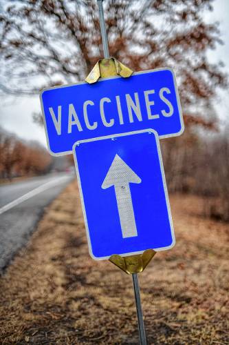 A sign leading into the COVID-19 vaccination site at the Keene State College athletic facility. Vaccine Sign A sign leading into the COVID-19 vaccination site at the Keene State College athletic facility. Vaccine Sign