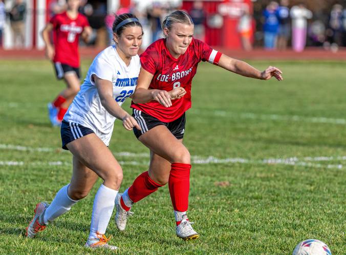 Coe-Brown captain Maggie Escabi (8) battles with Oyster River’s Lindsey Morin (22) in the middle of the pitch during a Division II girls’ soccer quarterfinal match on Saturday in Northwood. Coe-Brown overcame an early 1-0 deficit to win 5-2 and advance to the final four.