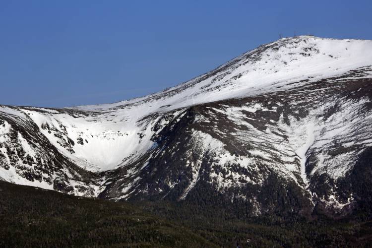 FILE - Tuckerman Ravine is seen at left, about one mile below the summit of 6,288-foot Mount Washington, in New Hampshire, Monday, May 4, 2015. (AP Photo/Robert F. Bukaty, File)