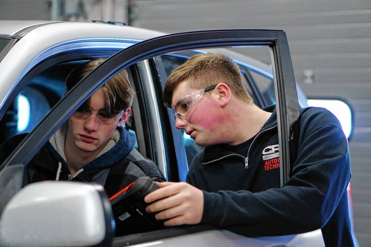 Ryan Schach, right, runs diagnostics with fellow Hopkinton student Travis Windhurst on Windhurst’s car at CRTC.