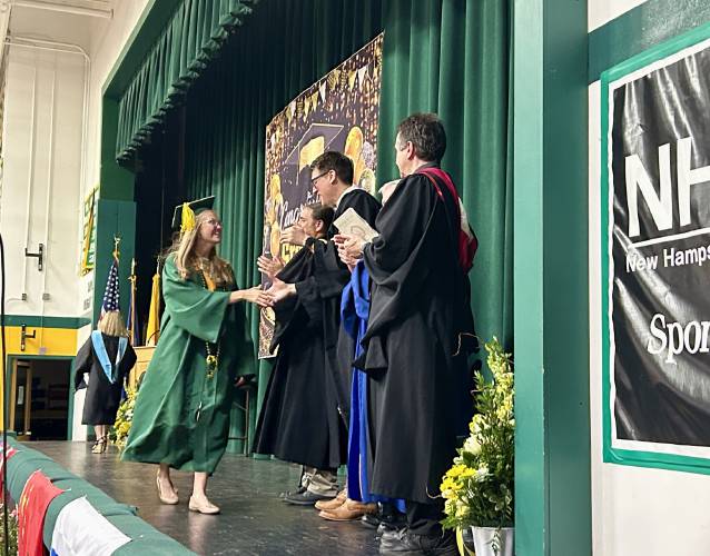 Valedictorian Avery Sahr shakes hands with school leaders after her speech at Bishop Brady High School's graduation in Concord on Friday, June 6, 2025.