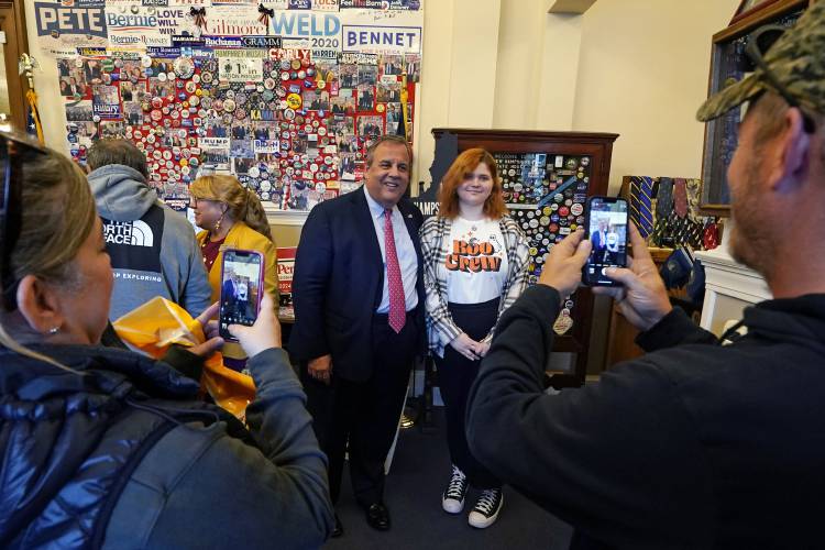 Republican presidential candidate and former New Jersey Gov. Chris Christie poses with Hailey Lesmerises, visiting from Germany, while stopping by the visitor's center at the State House, Thursday, Oct. 19, 2023, in Concord, N.H. (AP Photo/Charles Krupa)