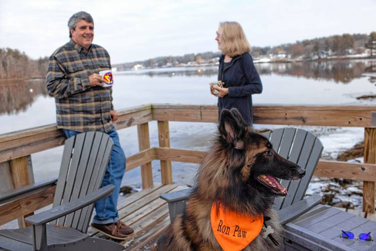 Dennis Pratt and his wife, Carol, enjoy their morning coffee while his dog, Ron Paw keeps watch on the deck of their condo near Dover Point in Dover on Thursday, February 1, 2024.