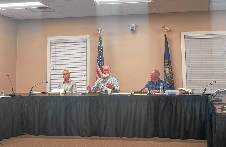 Jeff Miller, center, a select board member in Loudon, explains the 12% budget increase to residents at a public hearing Wednesday night. 