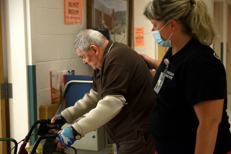 Licensed nursing assistant Raylynn Taylor assists Grafton County Nursing Home resident Paul Pinkham, 86, down the hall on Thursday, Sept. 14, 2023, in North Haverhill.