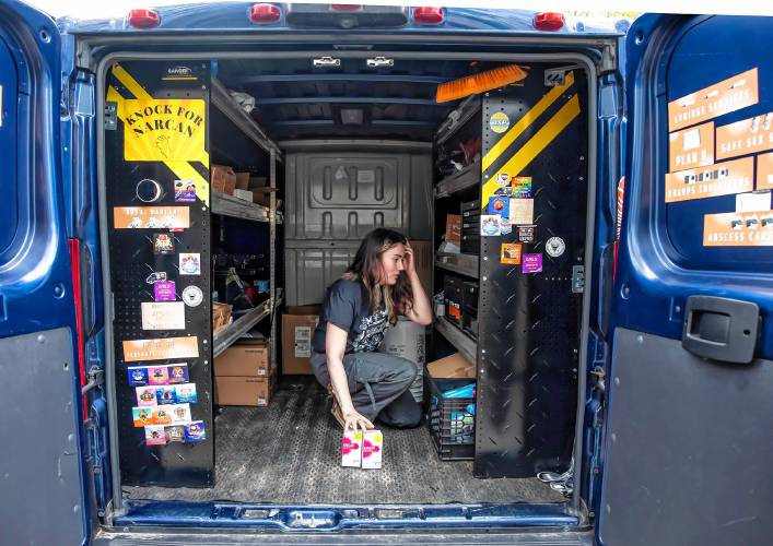 Director of Education and Technical Assistance for the NHHRC Liz Beaule goes over the checklist for items needed in the van.