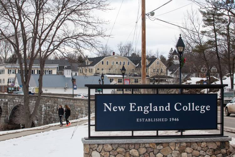 Students walk through campus in between classes at New England College in Henniker on Friday, Jan. 27, 2017. The bridge connecting campus to downtown Henniker is seen in the background. (ELIZABETH FRANTZ / Monitor staff)