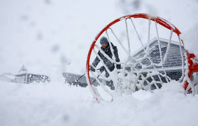 Jason Huber clears snow from his driveway, Tuesday, Jan. 9, 2024, in Walford, Iowa. (Jim Slosiarek/The Gazette via AP)