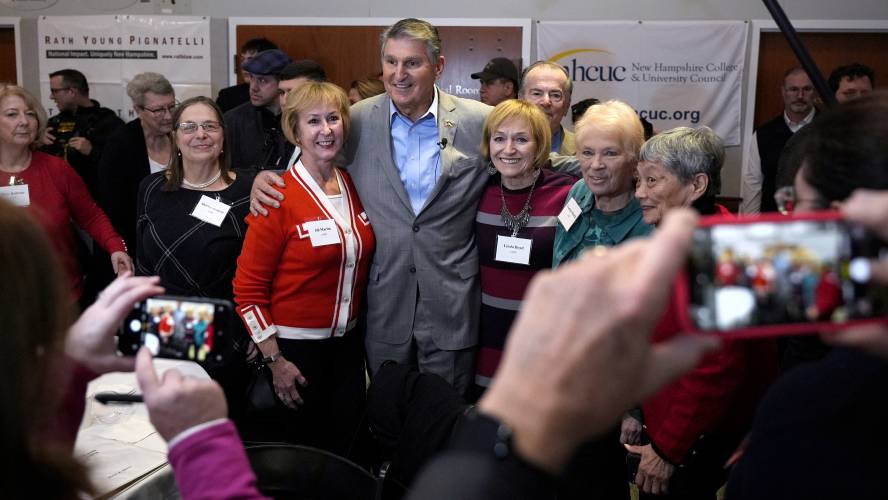 Sen. Joe Manchin, D-W.Va., second left, poses with guests during the Politics and Eggs event, as part of his national listening tour, Friday, Jan. 12, 2024, in Manchester, N.H. Manchin announced last November that he would not seek reelection in 2024 and has teased a potential third-party run for the presidency. (AP Photo/Charles Krupa)