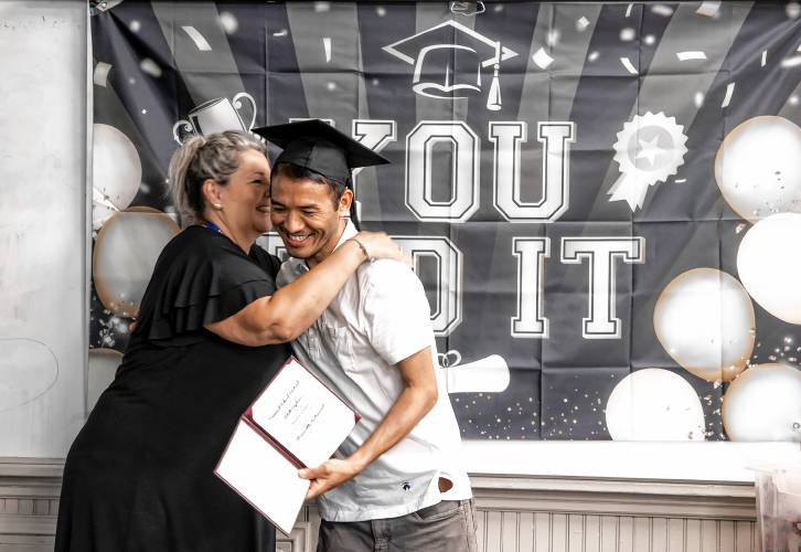 ABOVE: Maita Subba gets a hug from Kelly Dobin of the Second Start Program during the adult graduation party.