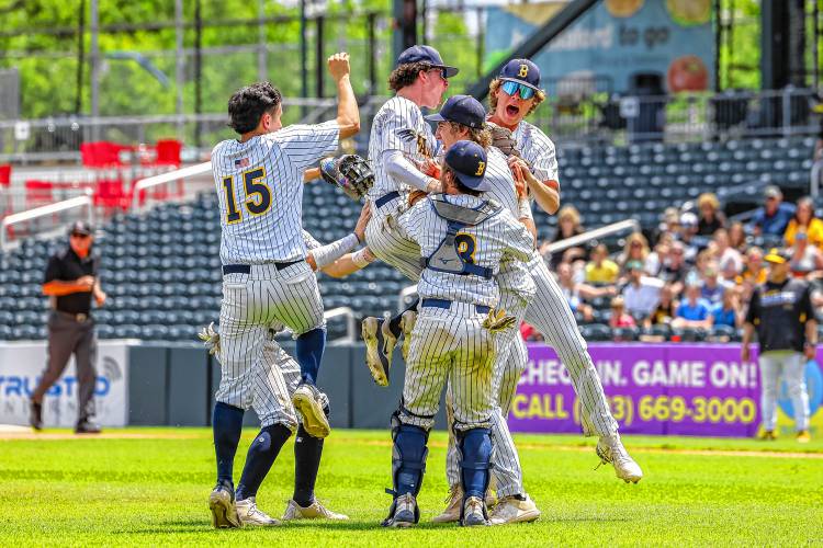 Bow celebrates around pitcher Sean Guerrette after closing out a 13-3 victory over Souhegan to win the Division II championship on Saturday at Delta Dental Stadium in Manchester.