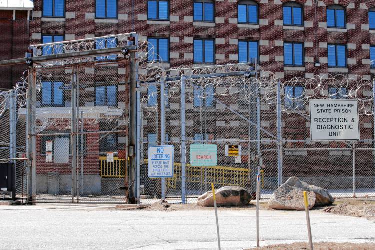 Razor wire hangs from the fence at the reception area at the New Hampshire State Prison for Men in Concord, N.H., Tuesday, March 31, 2020. Razor wire hangs from the fence at the reception area at the New Hampshire State Prison for Men in Concord, N.H., Tuesday, March 31, 2020.