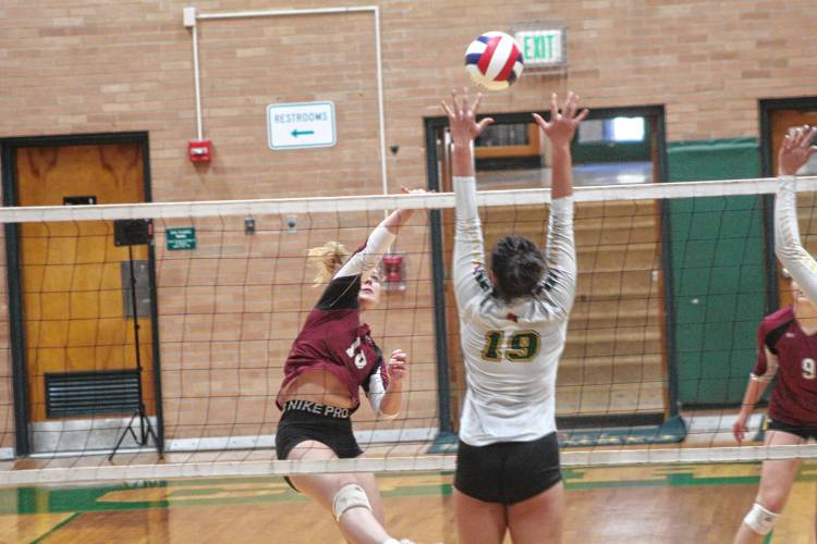 Concord’s Tess Bolduc tries to hit over the reach of Bishop Guertin’s Akira Coravos (19) during Saturday’s Division I girls’ volleyball quarterfinal in Nashua. No. 4 Bishop Guertin defeated No. 12 Concord in four sets.