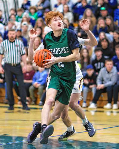 Pembroke’s Devin Riel (2) goes up for a layup during the Capital Classic boys’ basketball championship game at Pembroke Academy on Monday. Riel scored a game-high 17 points and shot 8-for-11 from the field to lead the Spartans to a 66-47 victory over ConVal.