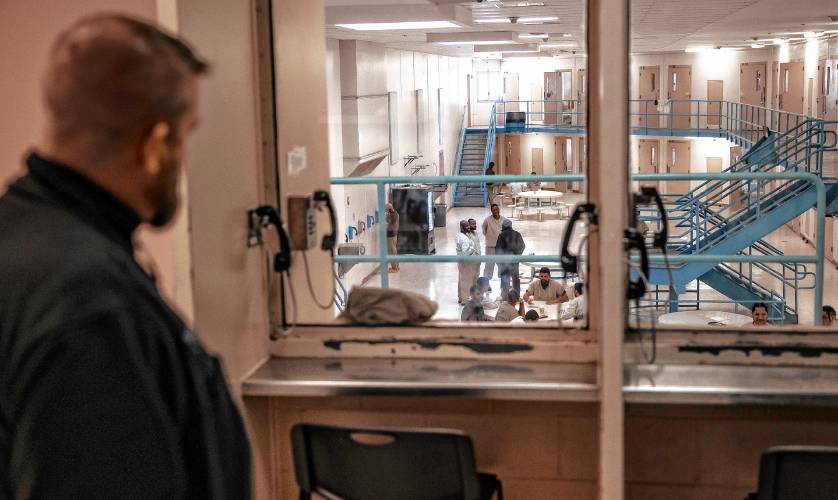 Strafford County Jail Superintendent Christopher Brackett looks through a window overlooking one of the units with a high percentage of inmates brought in by U.S. Immigrations and Customs Enforcement.