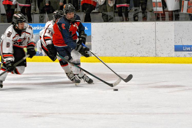 Belmont-Gilford’s Evan Guerin (6) skates up the ice with the puck during a Division III boys’ hockey semifinal on Wednesday at Plymouth State University’s Hanaway Rink. No. 4 Belmont-Gilford upset No. 1 Berlin-Gorham, 3-2, to advance to its third finals appearance in four years.