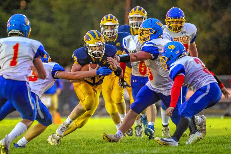 Bow QB Brady Lover tries to squeeze through the Gilford-Belmont defensive line during a 34-21 victory on Sept. 15.