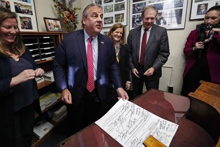 Republican presidential candidate and former New Jersey Gov. Chris Christie talks with reporters after filing paperwork to be on the Presidential Primary ballot at the State House, Thursday, Oct. 19, 2023, in Concord, N.H. (AP Photo/Charles Krupa)