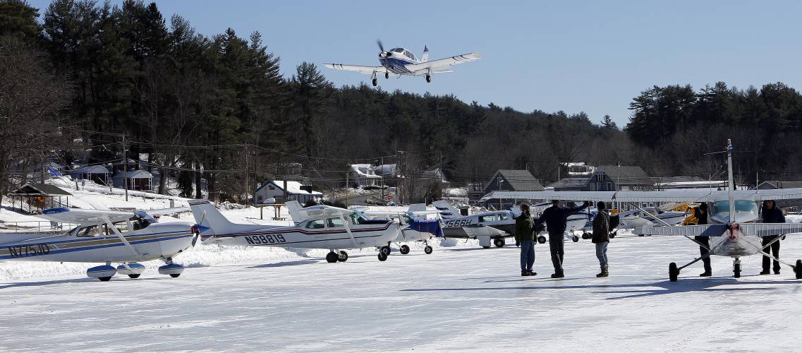 Planes fly into the ice runway on New Hampshire’s Lake Winnipesaukee on Saturday, Feb. 28, 2015, in Alton, N.H. 