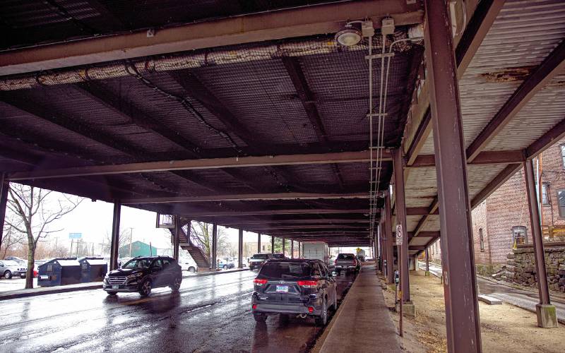 The steel beams of the parking garage have wire mesh to keep the crumpling concrete from falling onto Storrs Street.