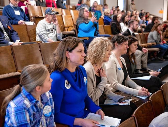 Sally Varney (center) puts her hand on her heart in the House gallery during the session which honored her partner, Art Ellison on Thursday morning. Joining Varney, from left is Abby Bates (Ellison’s granddaughter); Anna Bates, his daughter. And Varnery’s two daughters, Jill and Sarah, to her left.