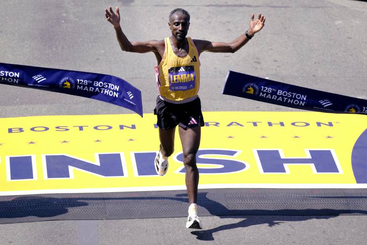 Sisay Lemma, of Ethiopia, breaks the tape to win the Boston Marathon, Monday, April 15, 2024, in Boston. (AP Photo/Charles Krupa)
