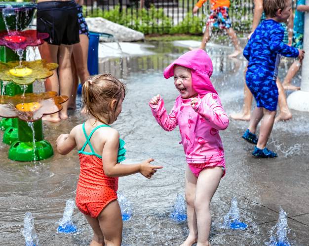 Nora Conway, 2, jumps with a friend at the White Park splash pad on Tuesday, June 18, 2024 as the tempertures reached the middle 90s by the time the pad was turned on. Conwayâs parents are teachers so they get time to enjoy the summer with their daughter.
